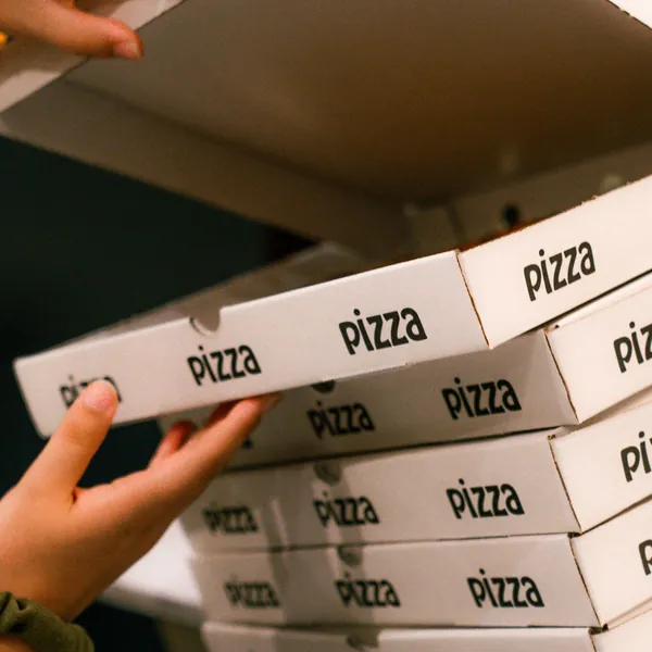 Stacked pizza boxes at a members night at Velvet