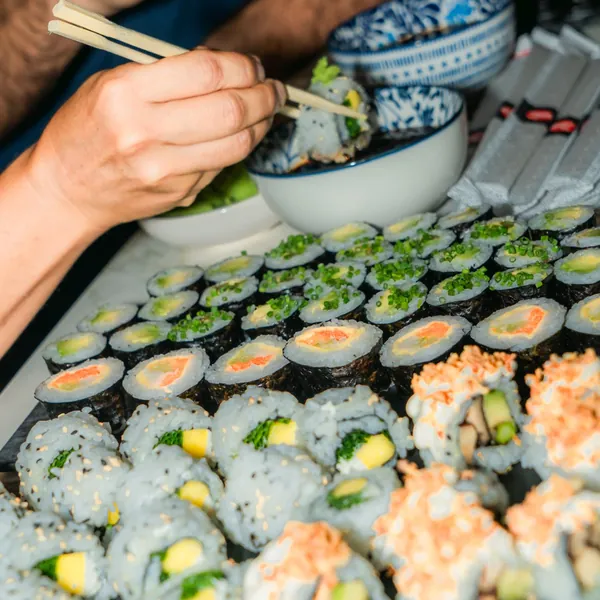 Members sharing sushi at a Velvet night